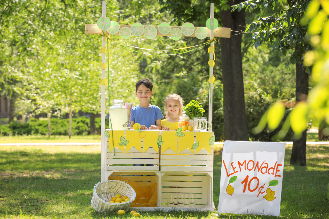 Young Boy and Girl Selling Lemonades Outdoors